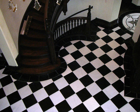 Magnificent grand foyer with checker board pattern stone tiles on the floor