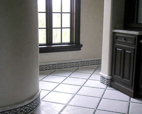 Master bathroom stone floor with stone mozaic baseboard