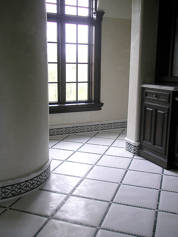 Master bathroom stone floor with stone mozaic baseboard