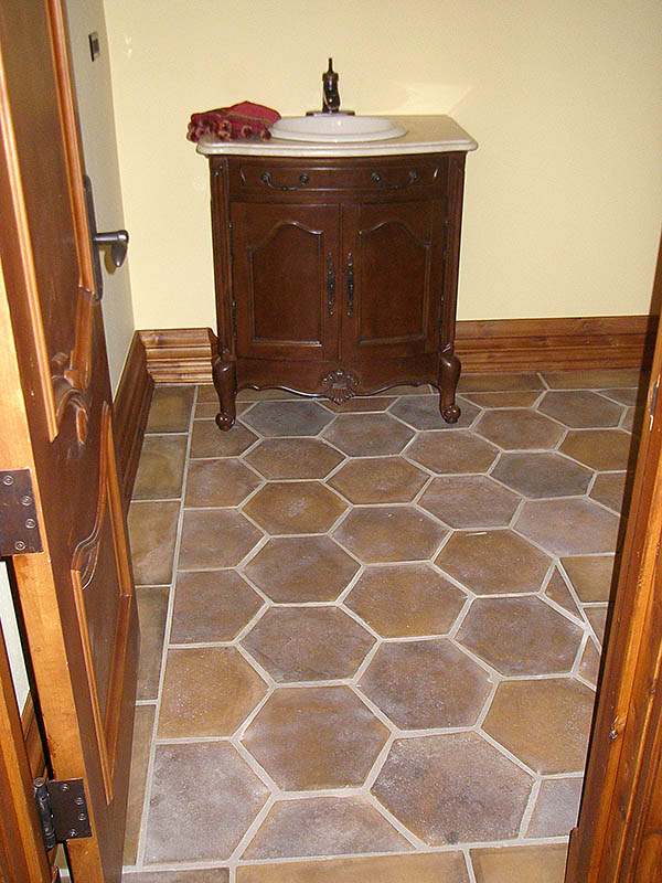 Powder room with concrete tiles on the floor