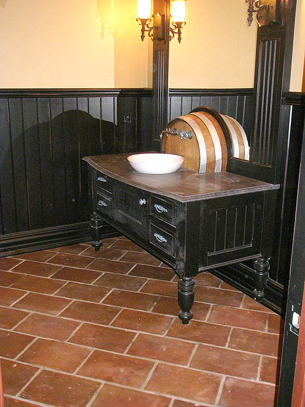 Powder room with spanish terracotta tiles on the floor